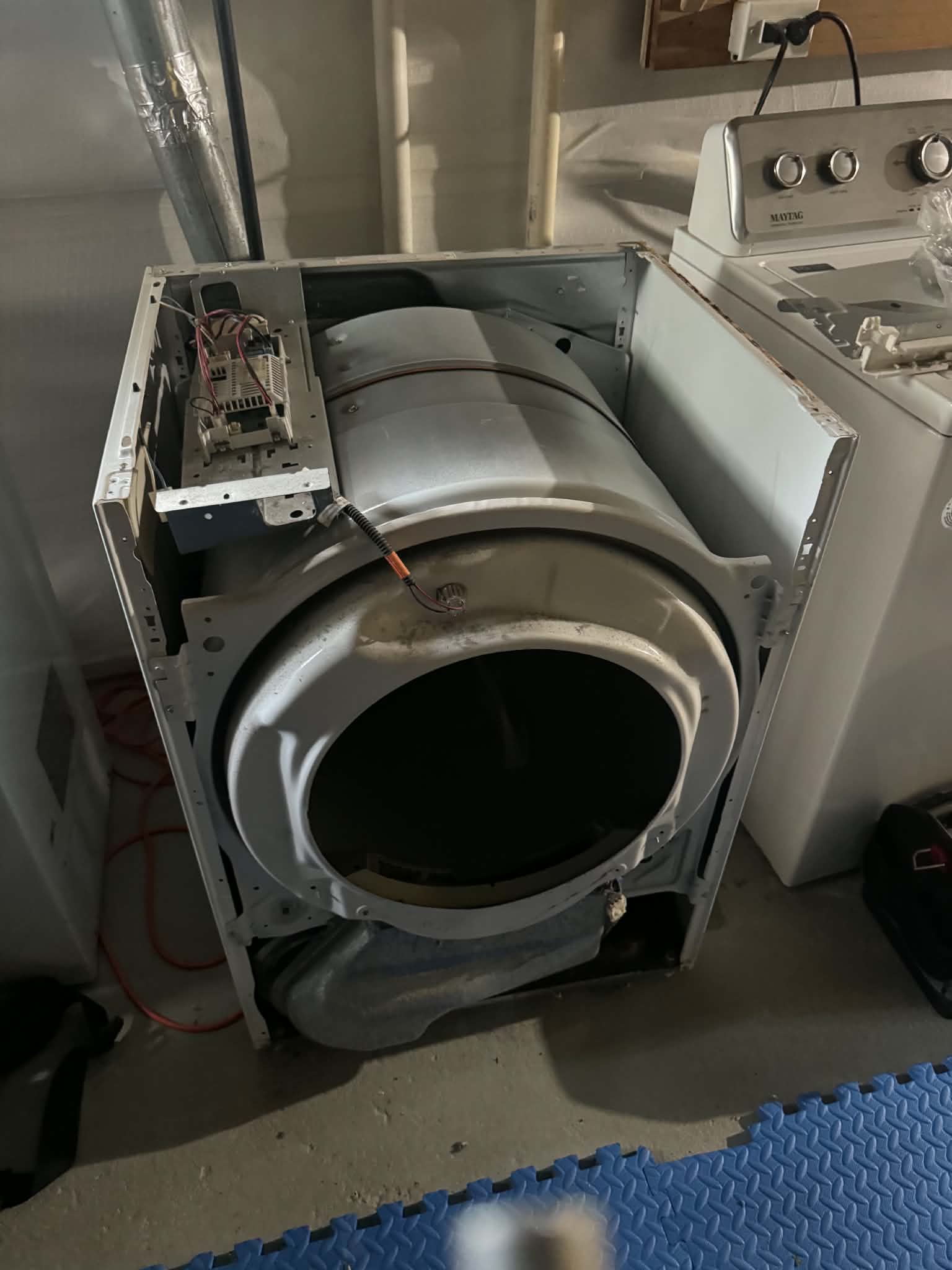 Lint-packed dryer vent duct behind a dryer that stopped heating