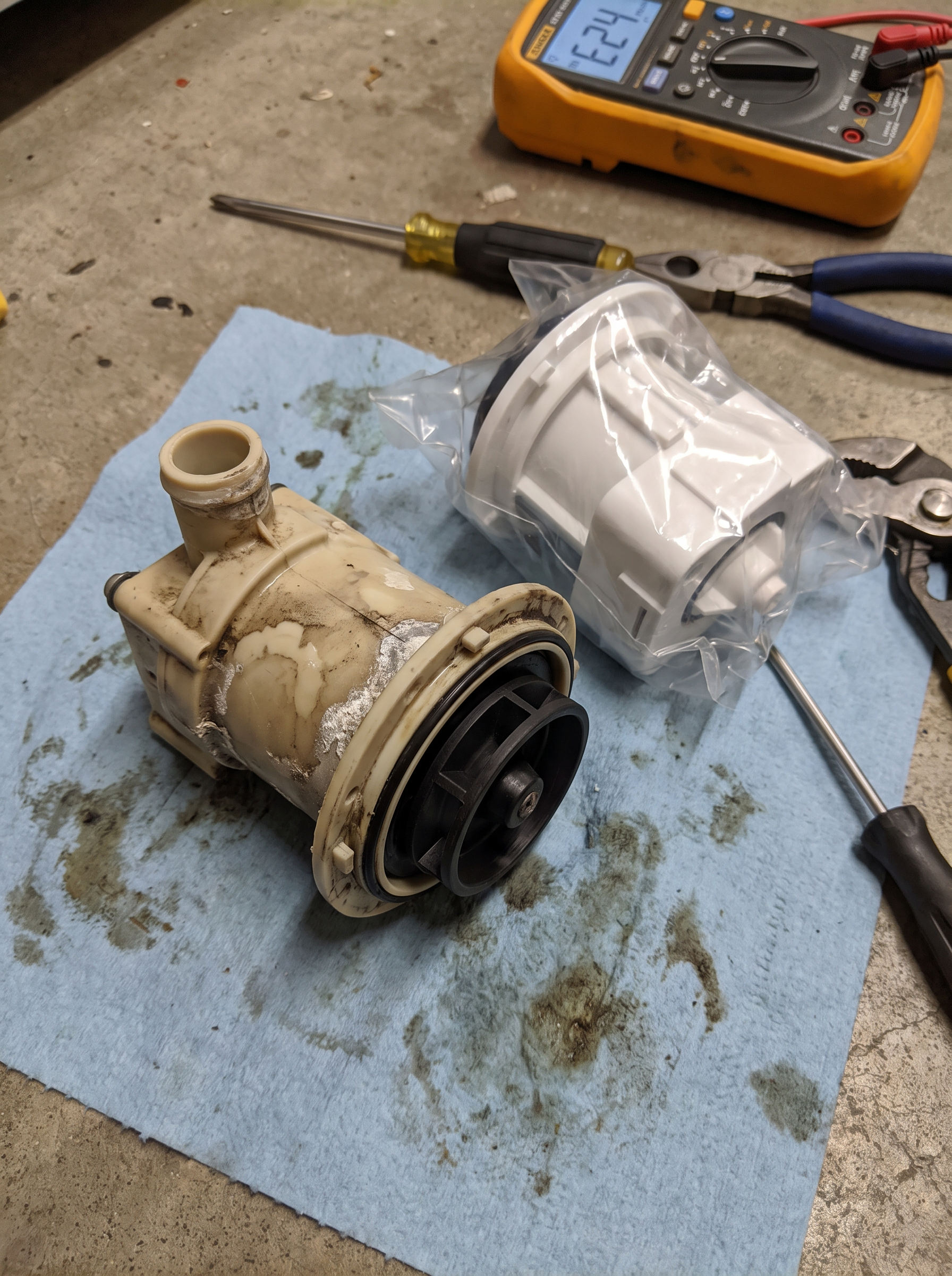 Failed dishwasher drain pump removed during an E24 repair