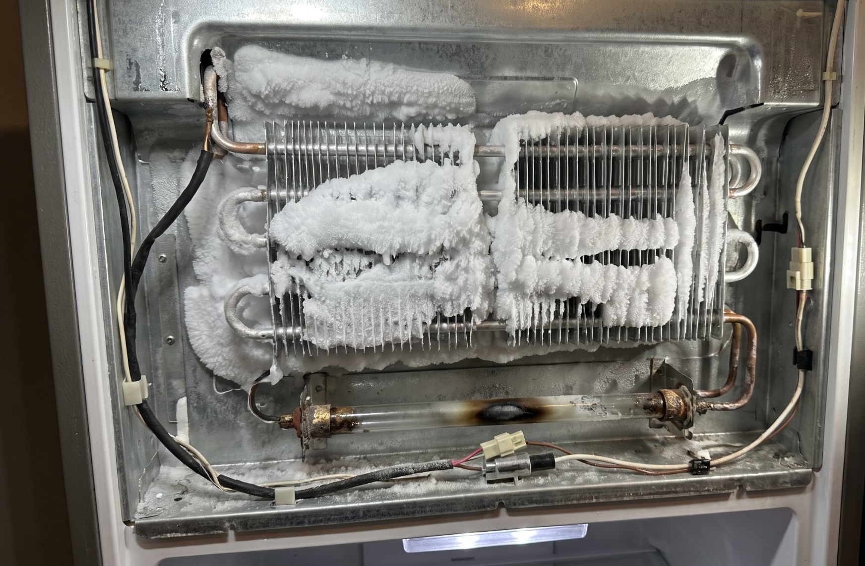 Iced-over evaporator behind a failed Samsung defrost heater