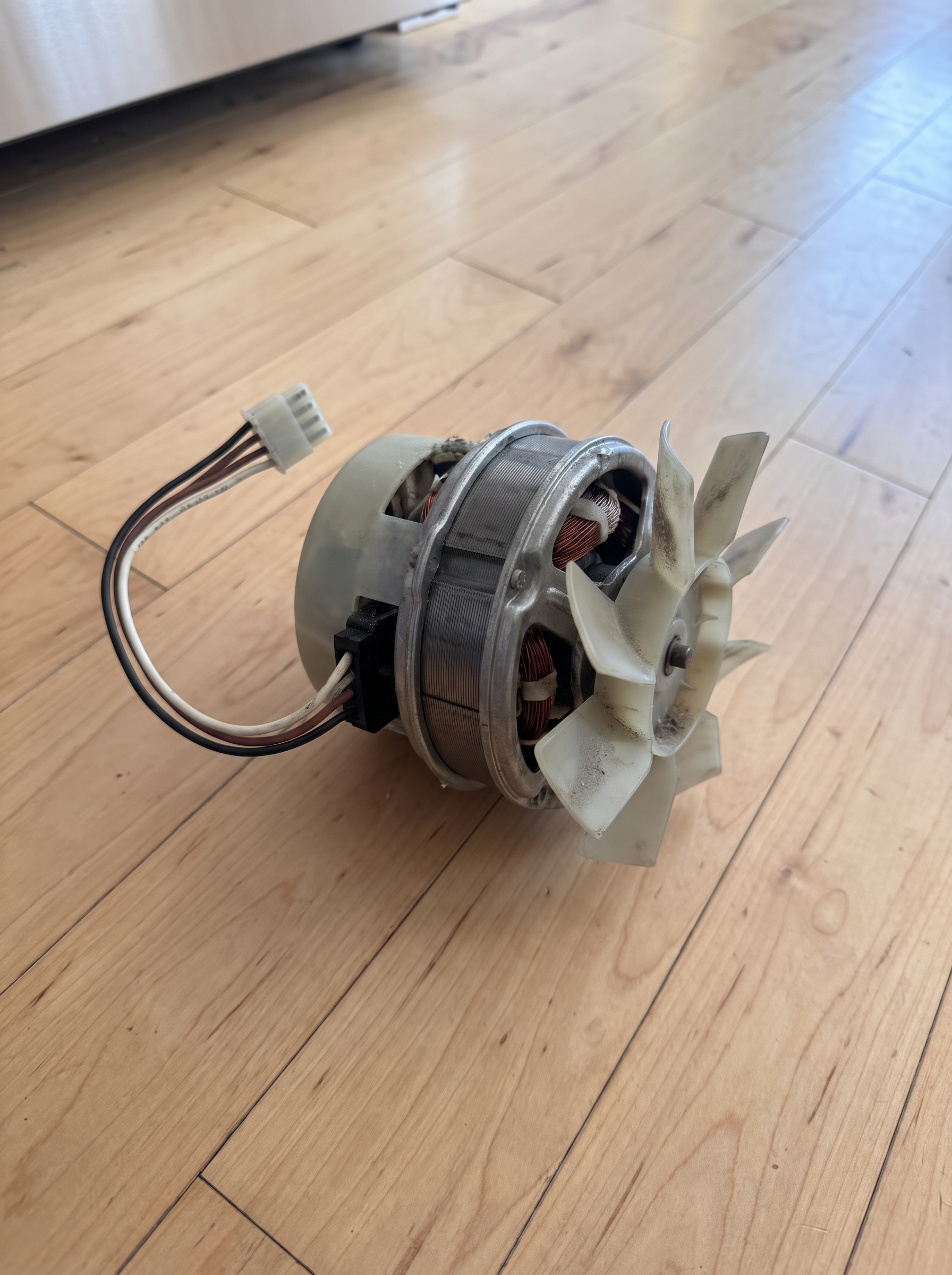 Failed evaporator fan motor removed from a GE refrigerator freezer